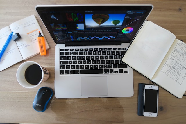 creative workspace laptop open notebook