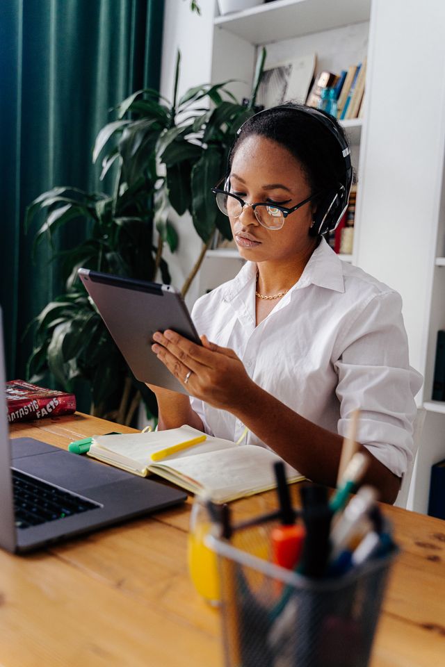 person looking at tablet and laptop online learning