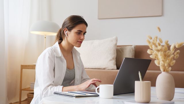 adult studying laptop home office