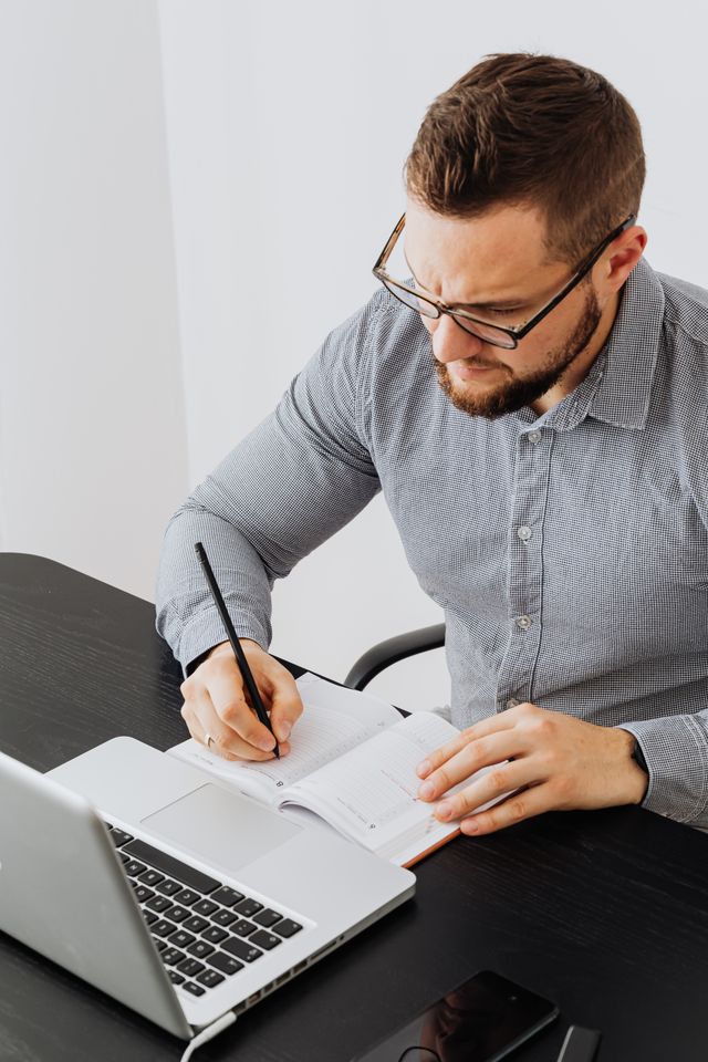 adult professional studying laptop desk