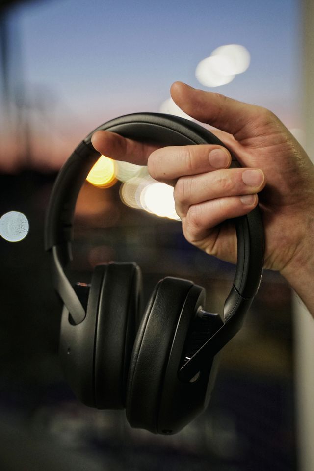 focused professional wearing noise canceling headphones