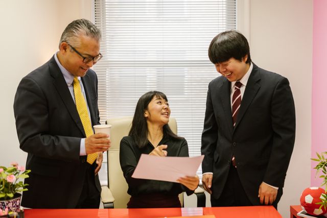 business people talking laughing corporate office